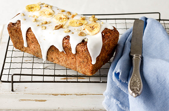 Gluten-free parsnip and pear loaf with vanilla icing, crumbled walnuts and dried banana chips.