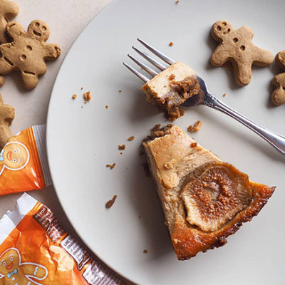 A slice of vegan, gluten-free gingerbread baked cheesecake with orgran Itsy Bitsy™ Gingerbread Friends.