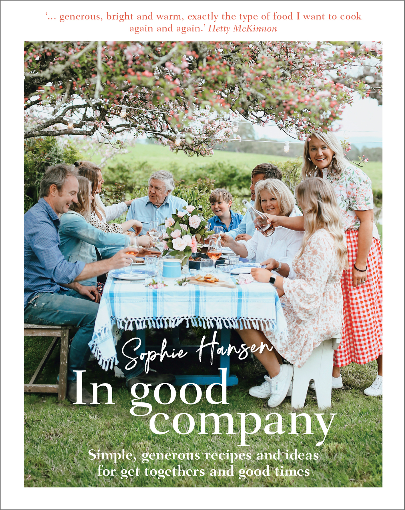 Cover of Images and text from In Good Company by Sophie Hansen; photography by Sophie Hansen. Murdoch Books RRP $39.99, image shows a group of people dining around a table outside under a tree.