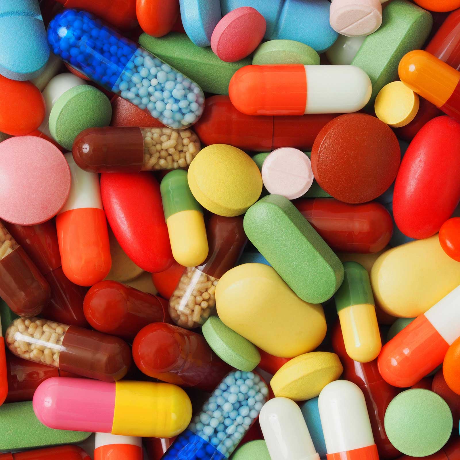 Assorted brightly coloured tablets, pills and capsules.