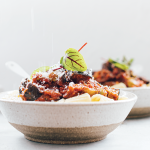 Two bowls of gluten-free pasta topped with thick & saucy vegetable bolognaise.